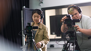 People on a set with video cameras.